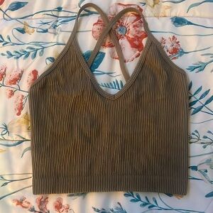 This is a light brown colored crop top with a crossed design in the back.